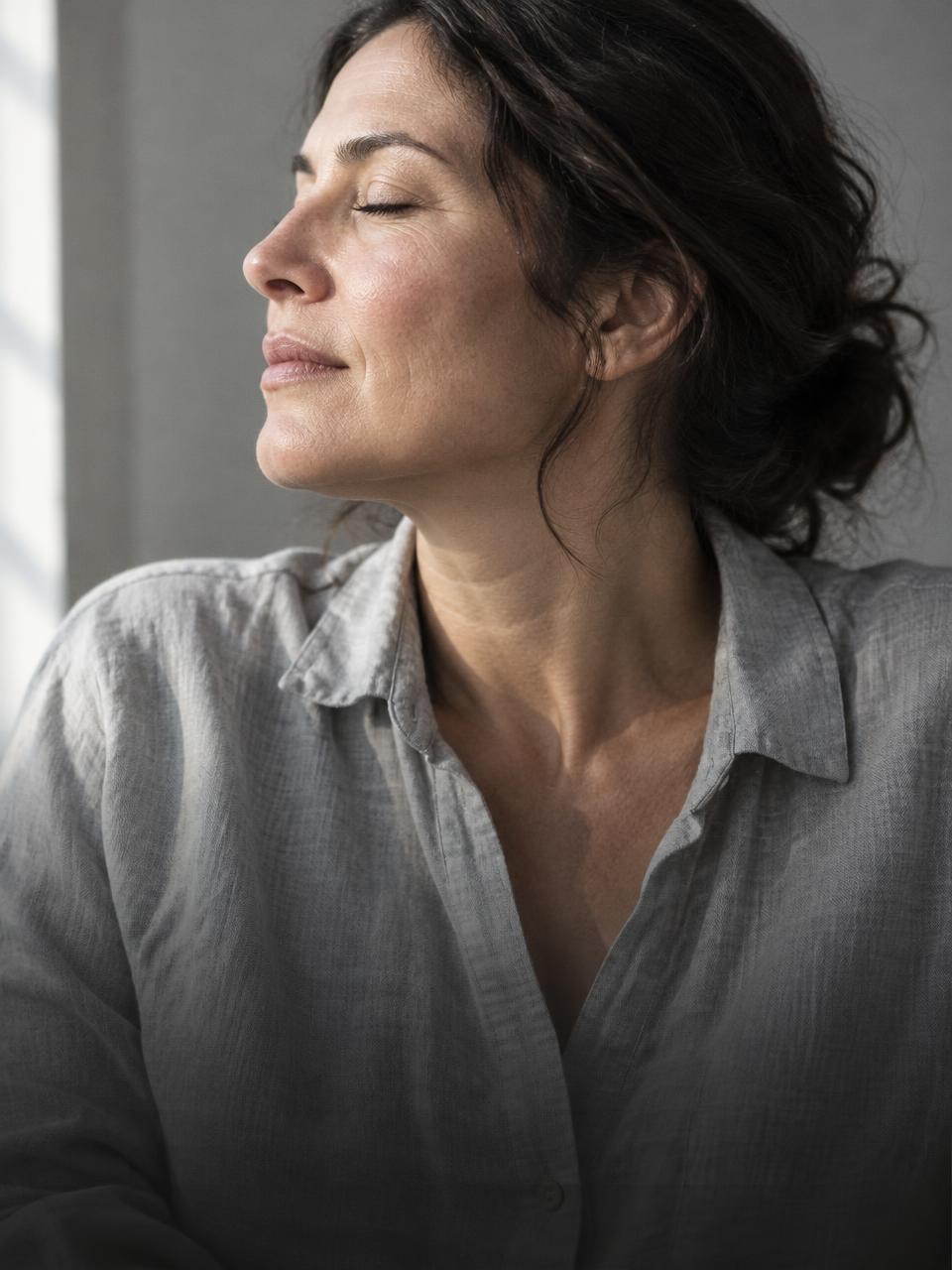Woman taking a quiet moment of rest in natural sunlight